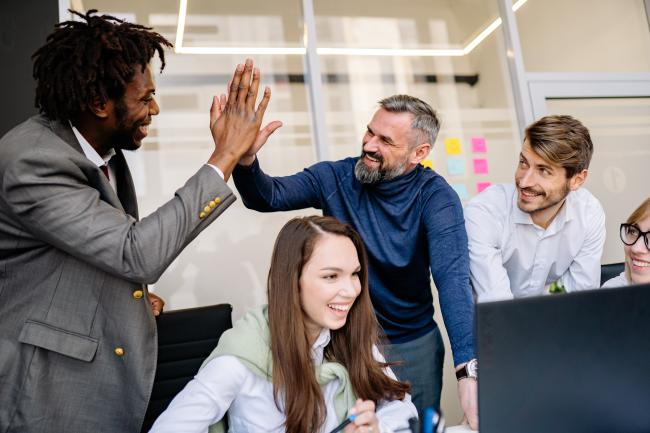 Diverse group of business professionals high-fiving